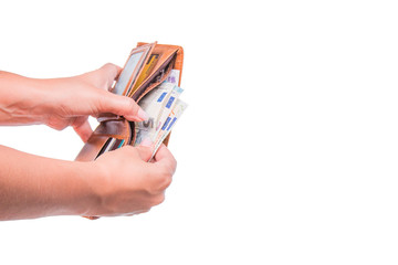 The hand takes out euro money from the wallet. Hand sharing euro banknotes. Financial, money exchange and donation concepts. Wallet with euro. Banknotes Isolated on white background.
