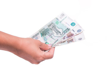 Human hand holding money, sharing ruble banknotes. Isolated on white background. Hand giving ruble banknotes in financial, money exchange and donation concepts.
