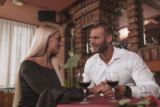 Beautiful romantic couple enjoys a romantic evening with wine.