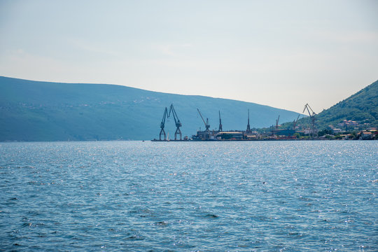 MONTENEGRO - JUNE 04/2017: in the seaport there is unloading of ships with large cranes.