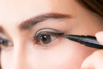 Naklejka premium Beautiful woman make-up with black eyeliner.