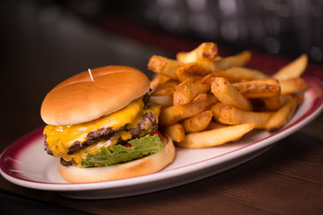 Close up on a double cheeseburger and crinkle french fries