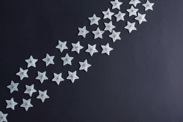 silver stars on a black background. holiday concept. creative layout