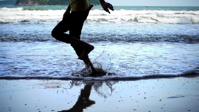 Woman runing on beach in slow motion.
