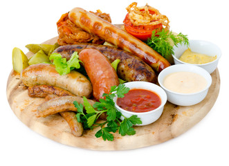 various sausages with sauces on wooden tray
