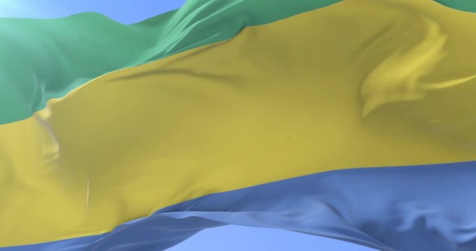 Gabonese flag waving at wind with blue sky in slow, loop