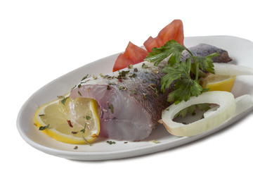 dish with a prepared raw piece of pikeperch fish with spices