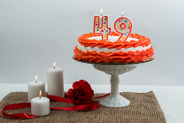 Frosted cake with 49 candle