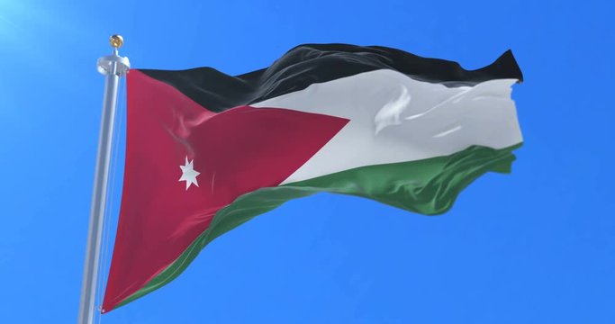 Flag of Jordan waving at wind with blue sky in slow, loop