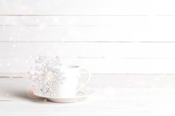 Winter drink with Christmas decoration snowflake. Copy space.