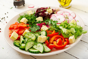Mix salad from fresh vegetables and greens herbs. Dietary menu. Proper nutrition. Healthy lifestyle.