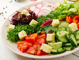 Mix salad from fresh vegetables and greens herbs. Dietary menu. Proper nutrition. Healthy lifestyle.