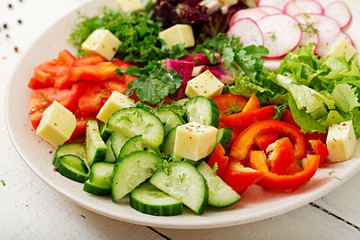 Mix salad from fresh vegetables and greens herbs. Dietary menu. Proper nutrition. Healthy lifestyle.