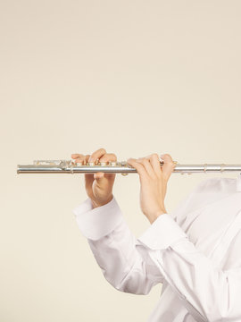 Flute music instrument in hands of flutist musician