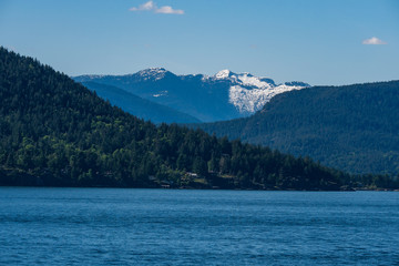 snow covered mountain, forest , ocean