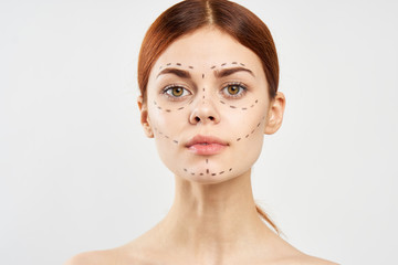 Young beautiful woman on white isolated background with outline on face, plastic surgery