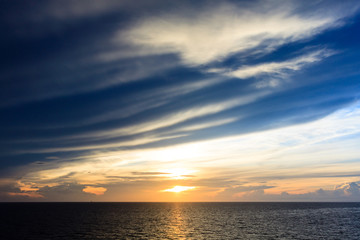 Blue sea and sky with sun red light in the middle sea