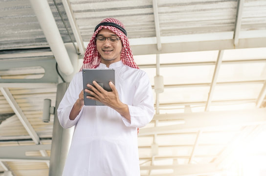 A handsome arab business man hold and browsing a digital tablet