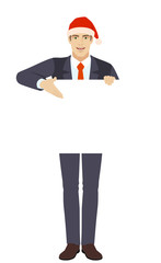 Businessman in Santa hat showing blank signboard