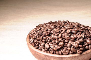 fresh coffee beans.coffee in a wooden bowl.