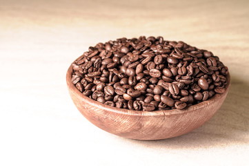 fresh coffee beans.coffee in a wooden bowl.