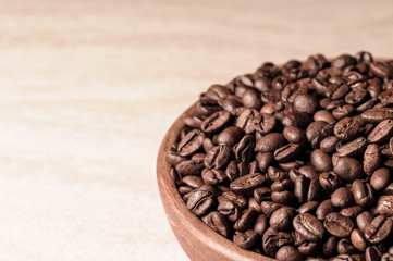 fresh coffee beans.coffee in a wooden bowl.