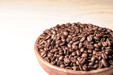 fresh coffee beans. coffee in a wooden bowl.