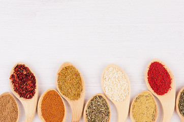 Spices collection on white soft wood board with copy space, top view, closeup.