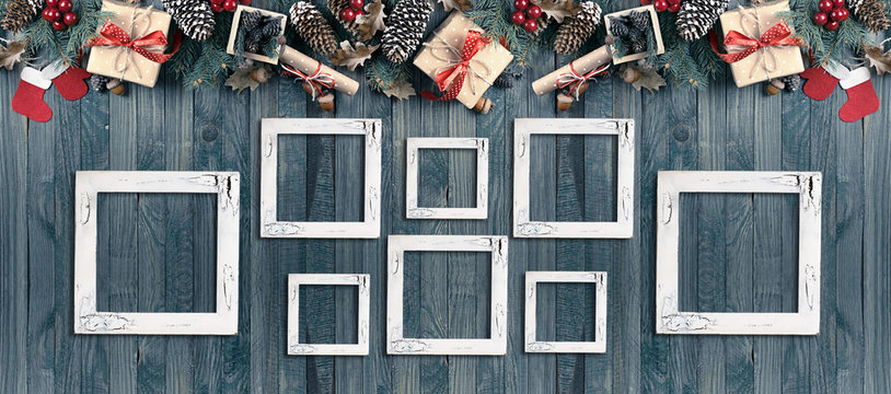 Christmas banner with photo frames, spruce, gift box, Santa Claus boots and scroll in vintage style on wooden boards background