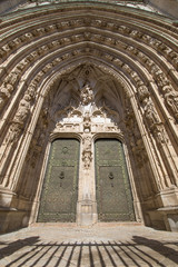 sculptures and ancient art reliefs on exterior facade of side door of the Primate Cathedral of Saint Mary, landmark and monument of the thirteenth century in Toledo city, Spain, Europe
