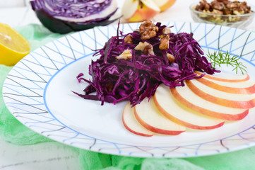 Light diet vegan salad of red cabbage, apple and walnuts. The Lenten dish. Proper nutrition.