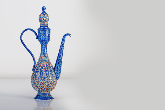Persian Rosewater Bottle Container With Enameling  (Minakari) Design handcrafted With Azure Blue Colors And Ornaments Patterns On The Surface Of Metal Isolated On White Background