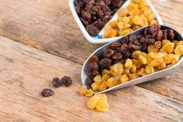 Raisins on a wood background.