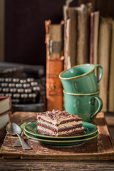 Sweet cake and coffee on desk writer