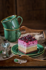 Delicious cake with black currant on green porcelain