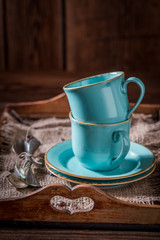 Rustic coffee cup and a plate on old burlap napkin