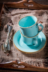 Rustic blue coffee cup on old burlap napkin