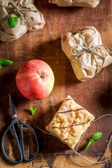 Sweet take away apple pie packed in a grey paper