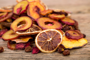 Close Up Of Pile Of Organic Raw Sun Dried Fruits Mix Of Oranges, Plum, Strawberries, Golden Berries And Peach On Wooden Table Background, Healthy Natural Snack, Selective Focus