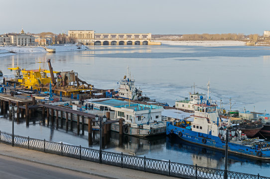 Picturesque view of Uglich town. Urban harbor and hydroelectric station on the frozen Volga River in sunny winter day