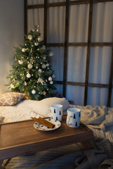 Couple of cup on vintage tray in bed and christmas tree. Flat lay