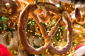 Pretzel with golden bows on fir twigs and pretzels background