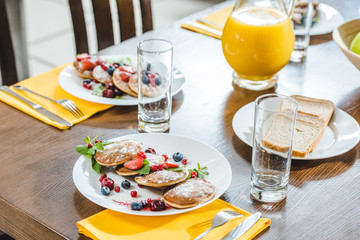 Fototapeta na wymiar pancakes with berries on plates