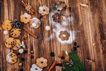 Delicious Christmas pastry, fir tree brances and cones on the wooden table