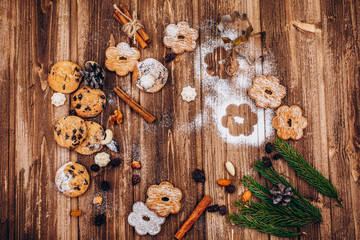 Delicious Christmas pastry, fir tree brances and cones on the wooden table