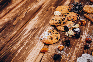 Delicious Christmas pastry, fir tree brances and cones on the wooden table
