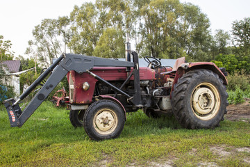 farm tractor, stands in the yard, old machine