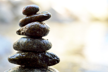 Zen stones stack from large to small on the river