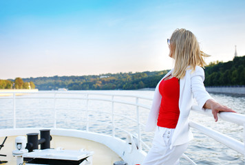 Fototapeta na wymiar Young pretty woman enjoying view on cruise ship deck