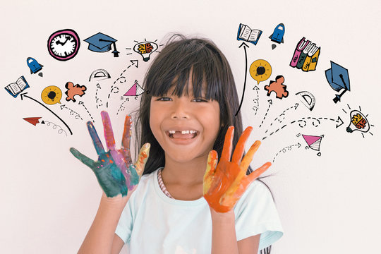 Education and Back to school concept- A head shot of toothless little girl smile with painted hands and back to school doodles